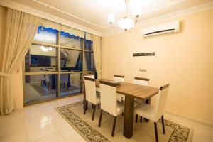 a dining room with a table and chairs and a window at Mete 2 Villa İcmeler Marmaris in İçmeler