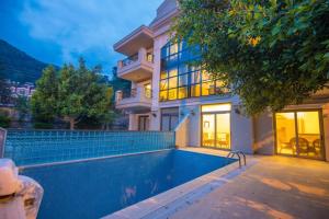 a house with a swimming pool in front of it at Mete 2 Villa İcmeler Marmaris in İçmeler