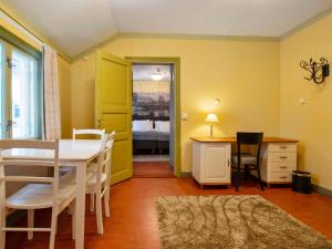 a dining room with a table and a bedroom at Holiday Home Kartanohuoneisto pekka by Interhome in Runni