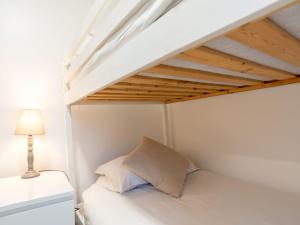 a bedroom with a bed under a loft bed at Chalet Wheal Tor Lodge by Interhome in Helston