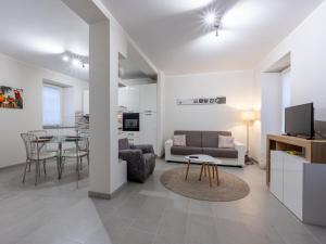 a living room with a couch and a table at Holiday Home Louna by Interhome in Mergozzo
