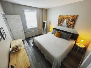 a bedroom with a large bed and a window at NEW Large Luxurious 2BR Condo in the Heart of Uptown Coffee, Wifi in Saint John