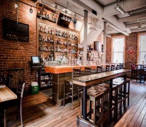 a bar in a restaurant with a brick wall at Bright Cozy Condo The Heart of Uptown 2BED Coffee & tea in Saint John
