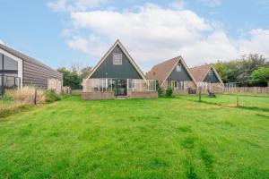 un grupo de casas en un patio en Nieuwlanderweg 77 en De Waal