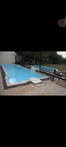 a large swimming pool with a fence around it at اكتوبر غرب سوميد in 6th Of October