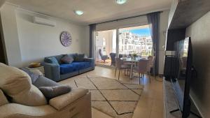 a living room with a blue couch and a table at First Floor Apartment on La Torre Golf Resort- BO1212LT in Torre-Pacheco