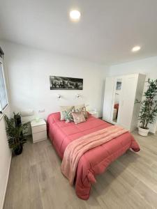 a bedroom with a large bed with a red blanket at Calma & Mar in Arona +30 photos