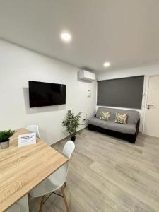 a living room with a table and a couch at Calma & Mar in Arona