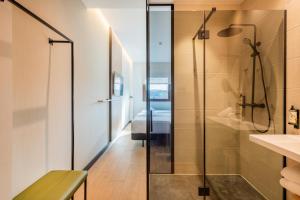 a bathroom with a shower and a sink at Leonardo Hotel San Sebastián in Donostia-San Sebastián