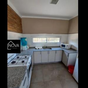 a kitchen with a stove and a microwave at COMPLEJO E.Y in Paso de la Patria