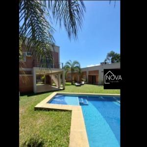 a villa with a swimming pool and a house at COMPLEJO E.Y in Paso de la Patria