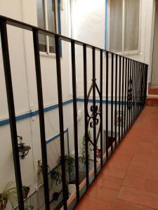 a balcony with a black fence with a swimming pool at PENSION CIBELES in Córdoba