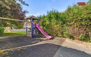 a playground with a slide in a yard at Charming and comfortable Apartment in Zürich