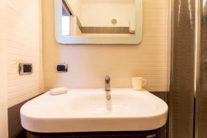 a white sink in a bathroom with a mirror at Gioia Romana in Rome