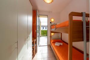 a small room with a bunk bed and a balcony at Camping Residence & Lodge Orchidea in Baveno +58 photos