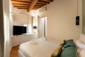 Habitación blanca con sofá y TV en TG - One bedroom luxury apartment in the fashion district, en Florencia