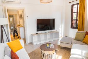 a living room with a couch and a tv at Boho Oldtown Apart in Antalya