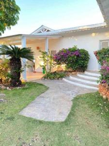 a house with a walkway in front of it at Villa Águila in Las Terrenas