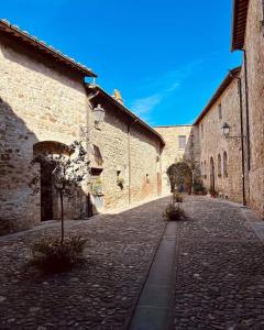 a cobblestone street in an alley with stone buildings at La Casina nel Borgo in Perugia