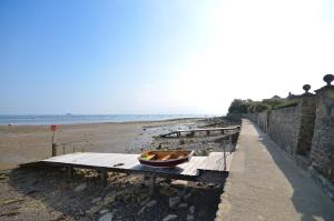 a boat sitting on a table on the beach at The Hideaway, 65 Salterns Beach Bungalows, Seaview in Seaview
