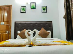 two swansrendered to look like they are kissing on a bed at Calangute Beach Empire in Calangute