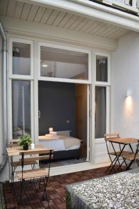 un patio con un letto in una camera con finestre di Rembrandtplein house A ad Amsterdam