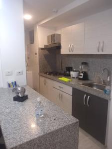 a kitchen with a sink and a counter top at APARTAMENTO AMOBLADO SECTOR MARAYA in Pereira