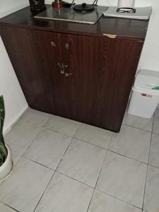 a bathroom with a wooden cabinet and a toilet at Къща за гости "Чекичев" in Svilengrad