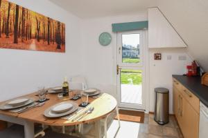 a kitchen with a wooden table with plates on it at Chalet Two in Deal