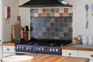 a kitchen with a stove top oven in a kitchen at Red House in Seaview