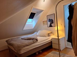a bedroom with a bed in a attic at Unik, stor leilighet i hjertet av Sandnes in Sandnes