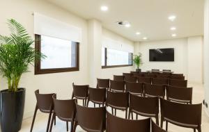 a conference room with chairs and a flat screen tv at Leonardo Hotel San Sebastián in Donostia-San Sebastián