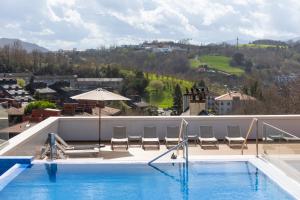 a swimming pool on the roof of a building at Leonardo Hotel San Sebastián in Donostia-San Sebastián