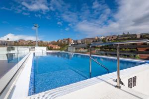 a large swimming pool on the roof of a building at Leonardo Hotel San Sebastián in Donostia-San Sebastián
