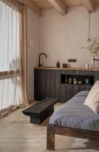 a bedroom with a bed and a bench next to a window at Cabañas Agotzenea in Zubiri