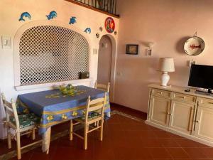 a kitchen with a table with a blue table cloth at PortoCervo Cala Del Faro in Arzachena