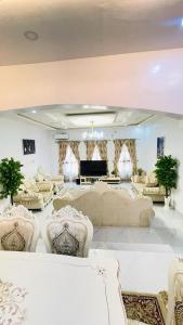 a large living room with a couch and chairs at House 5 in Ilorin