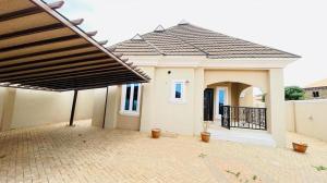 a small white house with a black roof at House 5 in Ilorin