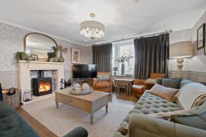 a living room with a couch and a fireplace at Cathedral House in Dornoch
