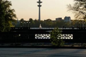a view of a bridge with a tower in the background at Alster-und Citynahes Apartment in Hamburg