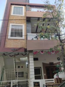 an apartment building with a balcony and a door at Madhuban Homestay 1 Ujjain in Ujjain