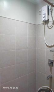 a bathroom with a shower stall with a toilet at Persimmon Studio Single Unit in Cebu City