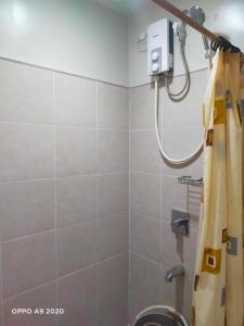 a bathroom with a shower with a shower curtain at Persimmon Studio Single Unit in Cebu City