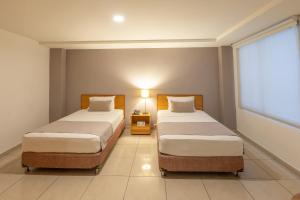Ένα ή περισσότερα κρεβάτια σε δωμάτιο στο Basic Hotel Centenario by Hoteles MS