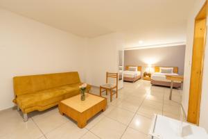 a living room with a couch and a table at Basic Hotel Centenario by Hoteles MS in Cali