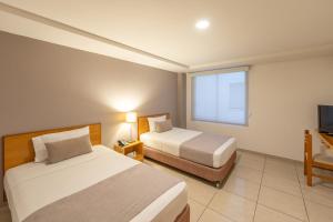 Ένα ή περισσότερα κρεβάτια σε δωμάτιο στο Basic Hotel Centenario by Hoteles MS