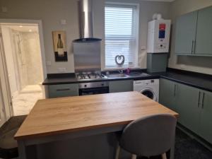 a kitchen with a wooden table and a counter top at Levy Nook 3 in Darlington