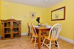a dining room with a wooden table and chairs at Pembroke Villa in Shanklin