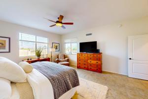 a bedroom with a bed and a ceiling fan at Pink Mountain Retreat in Tucson