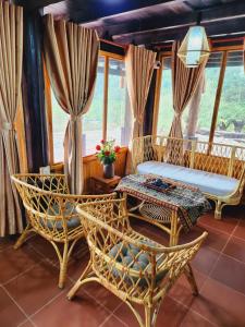 a room with chairs and a couch and a table at Ngũ Chỉ Sơn Trekking Sapa in Sapa